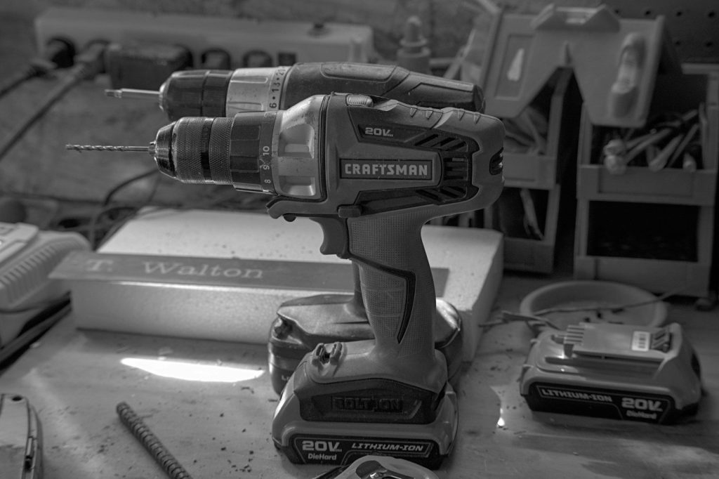 a black and white photo of a cordless drill