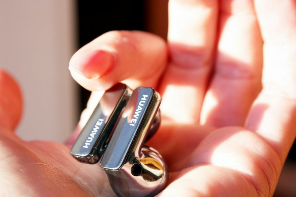 a person holding a small electronic device