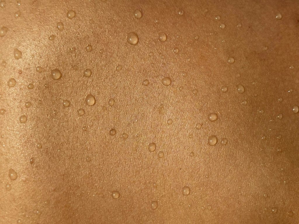 A man's back with water drops on it